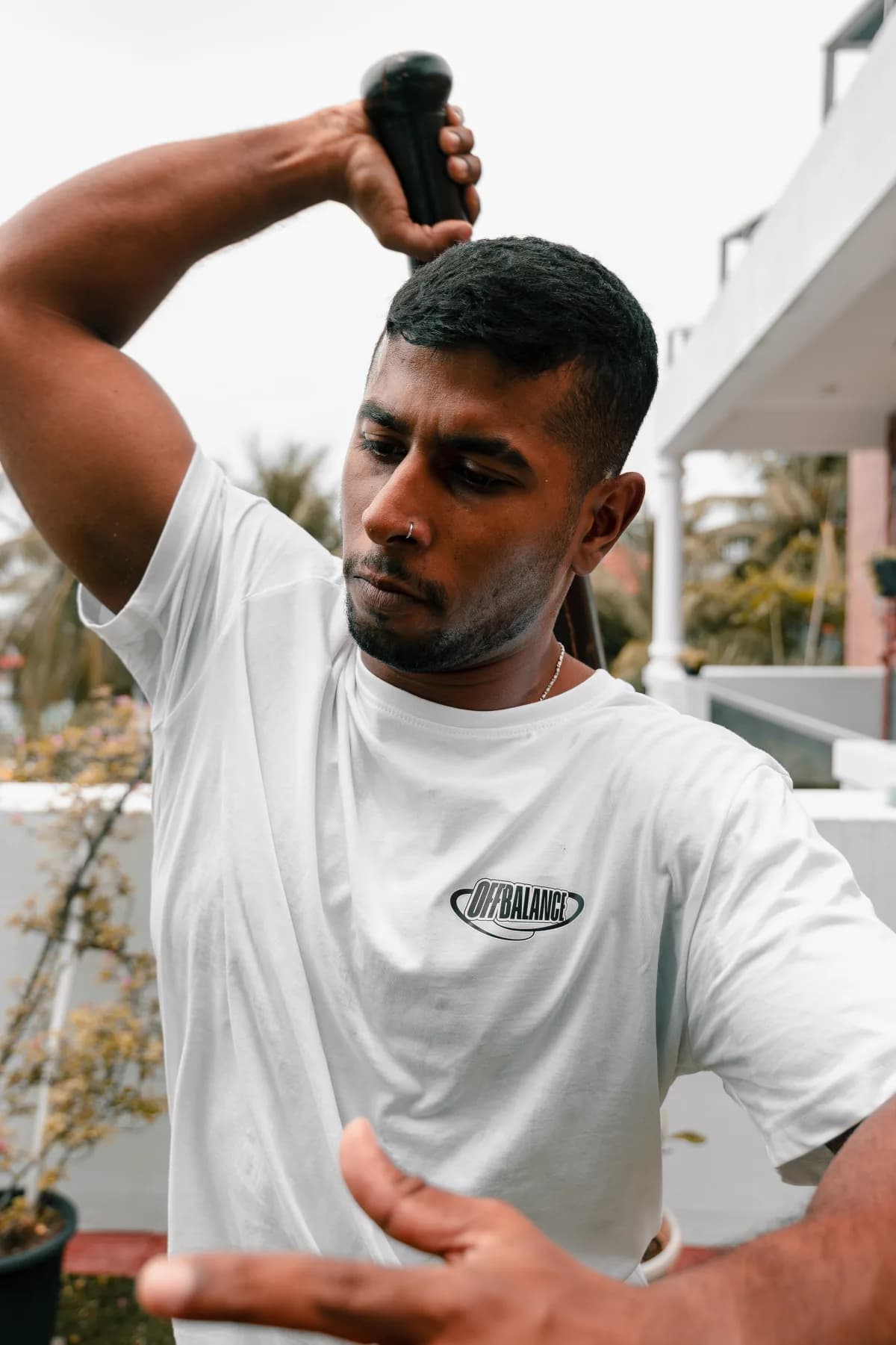 Off Balance coach CJ training with a gada — traditional Indian strength training for fitness and wellbeing