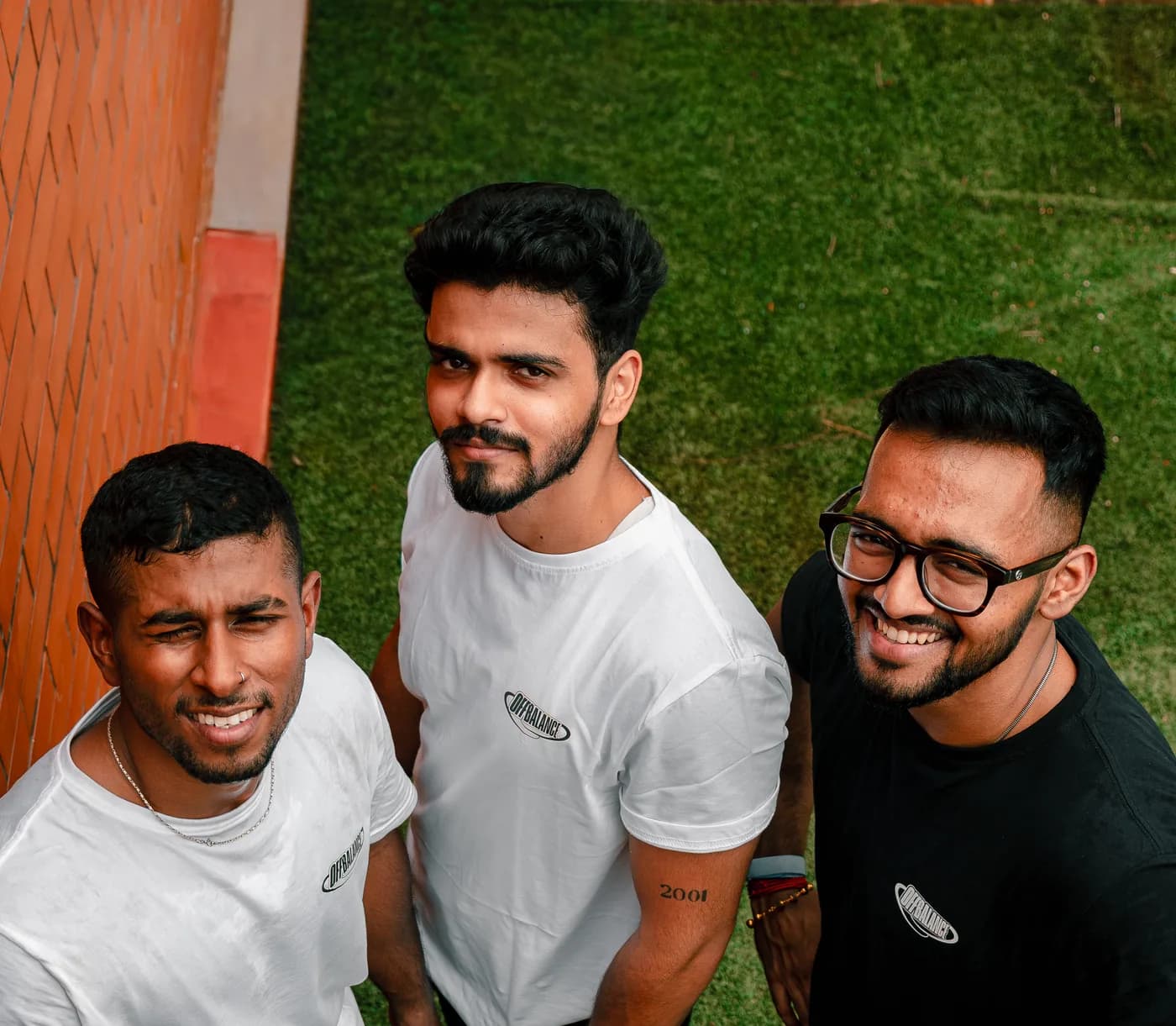 Three members of the Off Balance team looking up at the camera in Off Balance shirts