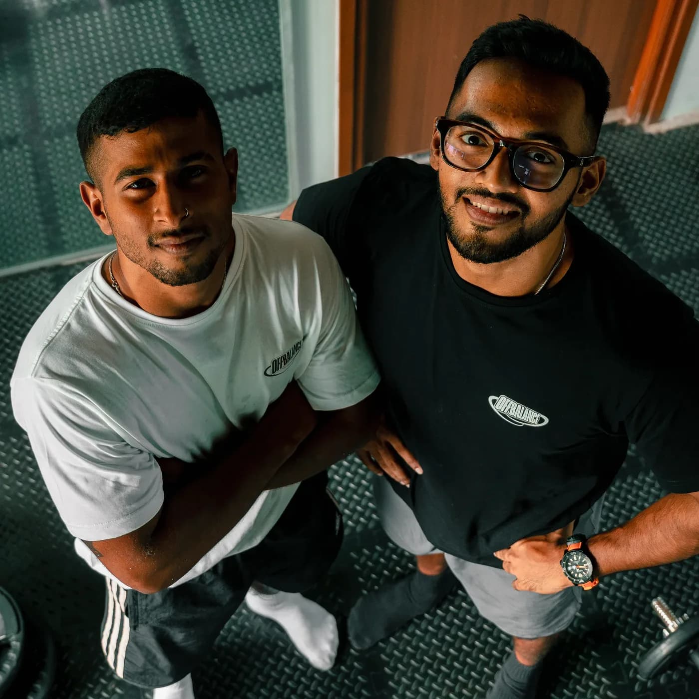 CJ and Achuthan looking up at the camera in Off Balance shirts
