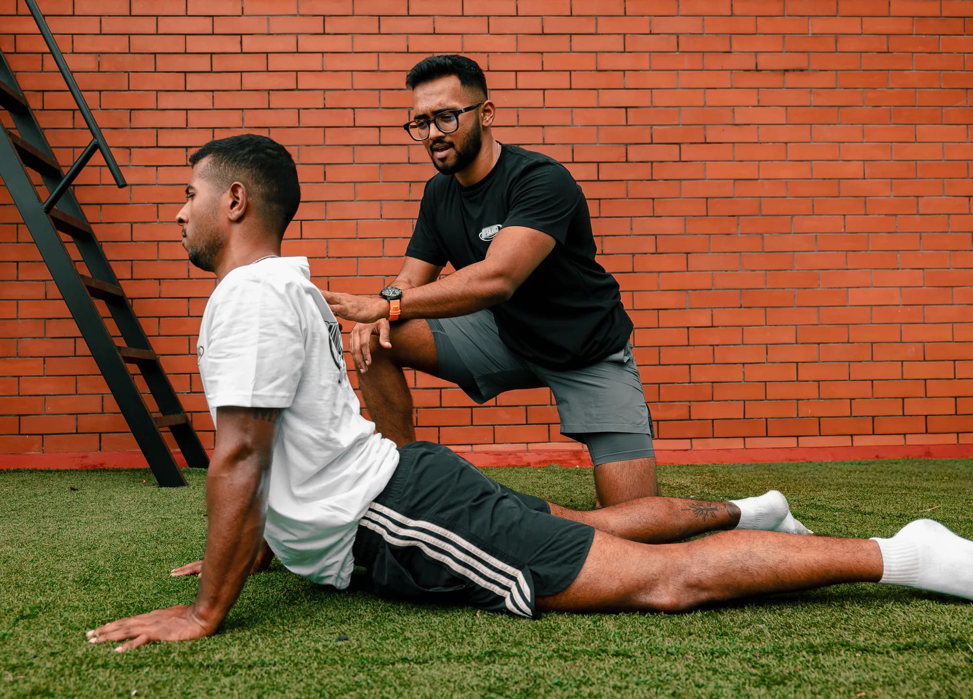 Achuthan coaching CJ through a movement